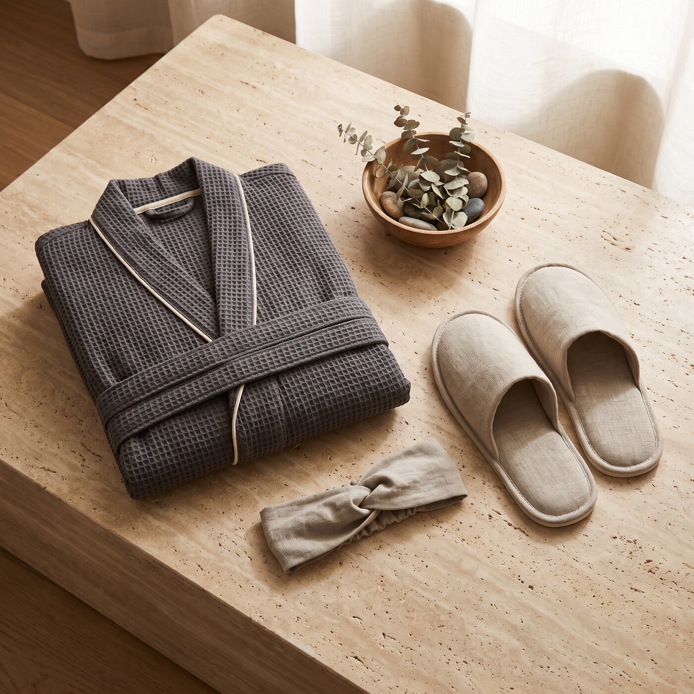 Folded spa robe with wellness slippers and headband